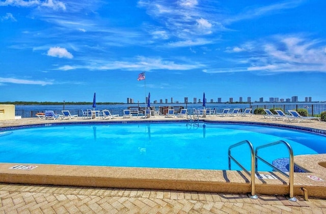 100 Paradise Harbour Blvd Unit 502, North Palm Beach, FL 33408 - community pool with a view of skyline and a patio area