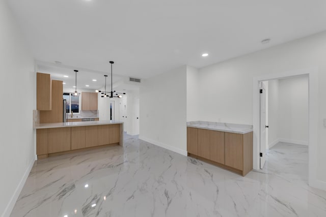100 Paradise Harbour Blvd Unit 502, North Palm Beach, FL 33408 - kitchen featuring light marble finish flooring, baseboards, modern cabinets, recessed lighting, and a peninsula