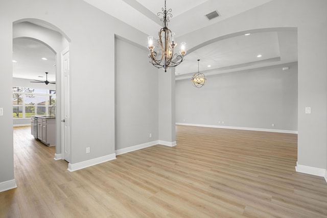 17009 SW Sapri Way, Port Saint Lucie, FL 34986 - unfurnished room featuring recessed lighting, arched walkways, light wood-style flooring, baseboards, and a chandelier