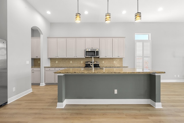 17009 SW Sapri Way, Port Saint Lucie, FL 34986 - kitchen with appliances with stainless steel finishes, backsplash, light wood-style floors, and recessed lighting