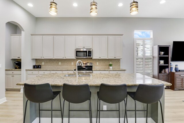 17009 SW Sapri Way, Port Saint Lucie, FL 34986 - kitchen featuring stainless steel appliances, light wood-type flooring, backsplash, and recessed lighting