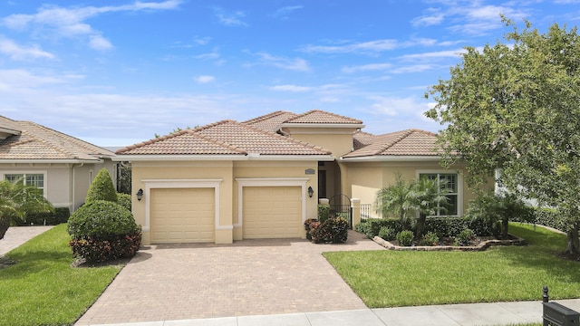 17009 SW Sapri Way, Port Saint Lucie, FL 34986 - view of front of home with a garage, decorative driveway, a front lawn, and stucco siding