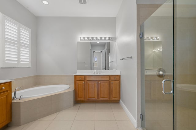 17009 SW Sapri Way, Port Saint Lucie, FL 34986 - bathroom with vanity, a garden tub, a stall shower, and tile patterned floors