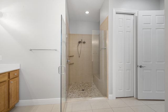 17009 SW Sapri Way, Port Saint Lucie, FL 34986 - bathroom with a stall shower, a closet, vanity, tile patterned floors, and baseboards