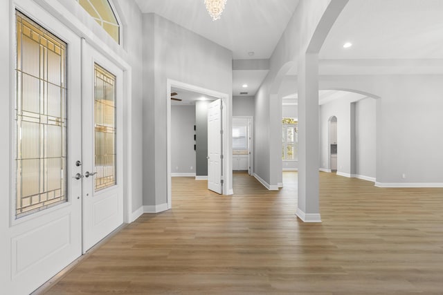 17009 SW Sapri Way, Port Saint Lucie, FL 34986 - foyer entrance with arched walkways, recessed lighting, light wood-type flooring, and baseboards