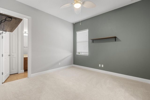17009 SW Sapri Way, Port Saint Lucie, FL 34986 - unfurnished bedroom with light carpet, baseboards, ceiling fan, and connected bathroom