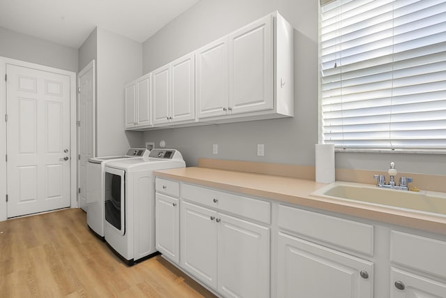 17009 SW Sapri Way, Port Saint Lucie, FL 34986 - laundry area with washer and dryer, cabinet space, and light wood finished floors