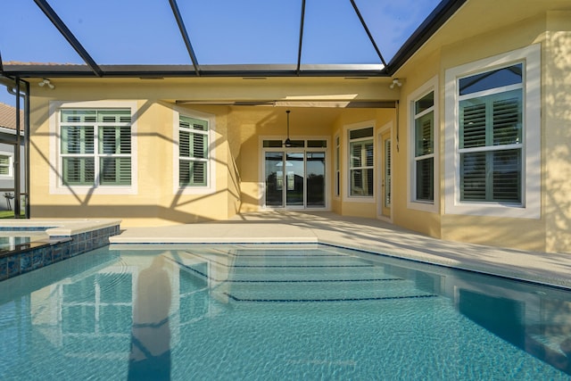 17009 SW Sapri Way, Port Saint Lucie, FL 34986 - view of swimming pool featuring glass enclosure, a patio area, and a pool with connected hot tub