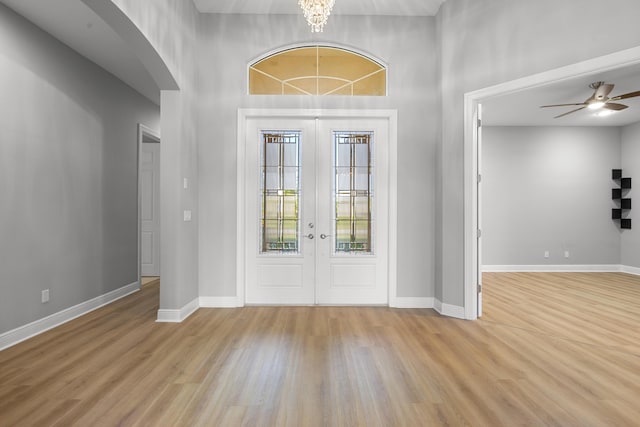 17009 SW Sapri Way, Port Saint Lucie, FL 34986 - foyer entrance featuring french doors, wood finished floors, and baseboards