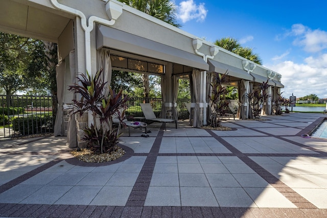 17009 SW Sapri Way, Port Saint Lucie, FL 34986 - view of patio with fence and a water view