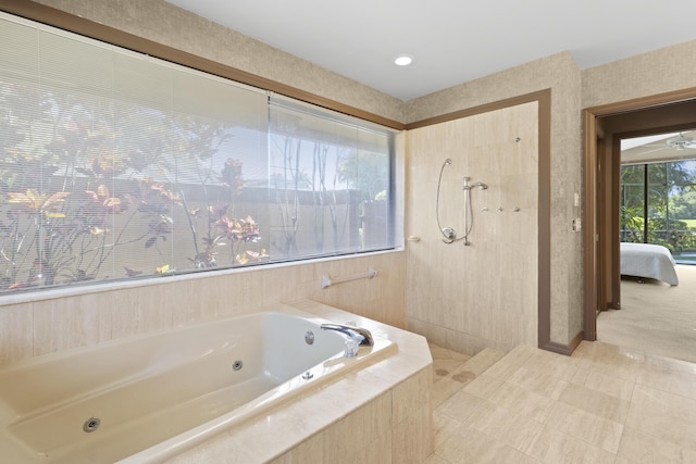 ensuite bathroom with a whirlpool tub and tiled shower
