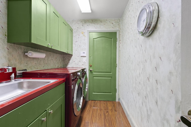 laundry area with cabinet space, wood finished floors, washing machine and dryer, and wallpapered walls