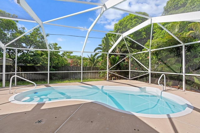 1042 SW Janette Ave, Port Saint Lucie, FL 34953 - view of swimming pool with a lanai and a patio