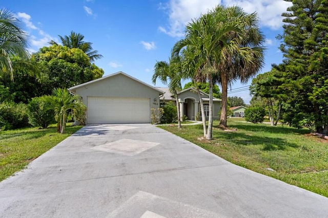 1042 SW Janette Ave, Port Saint Lucie, FL 34953 - view of front facade featuring concrete driveway, a front yard, and an attached garage