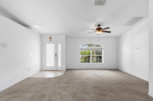 1042 SW Janette Ave, Port Saint Lucie, FL 34953 - unfurnished room with light carpet, a ceiling fan, and light tile patterned floors