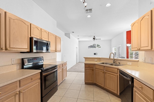 1042 SW Janette Ave, Port Saint Lucie, FL 34953 - kitchen with stainless steel appliances, light brown cabinetry, light countertops, a ceiling fan, and recessed lighting