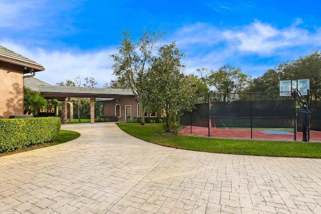 view of tennis court featuring fence
