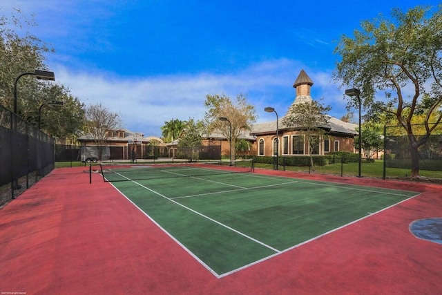 view of tennis court with fence and community basketball court