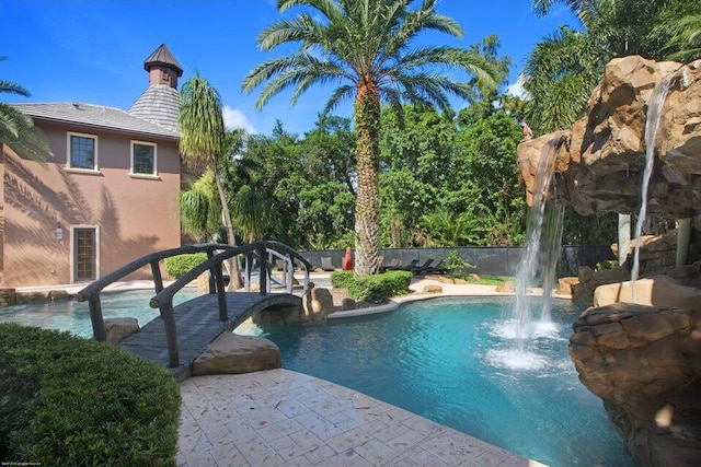 view of swimming pool with fence