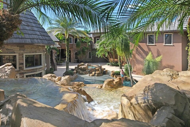 view of patio / terrace featuring an outdoor stone fireplace