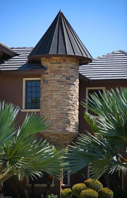exterior view of stucco siding, stone siding, and a standing seam roof