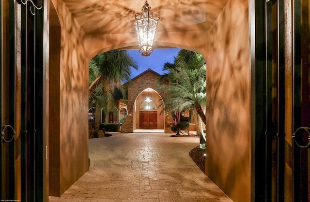 foyer with a chandelier and arched walkways