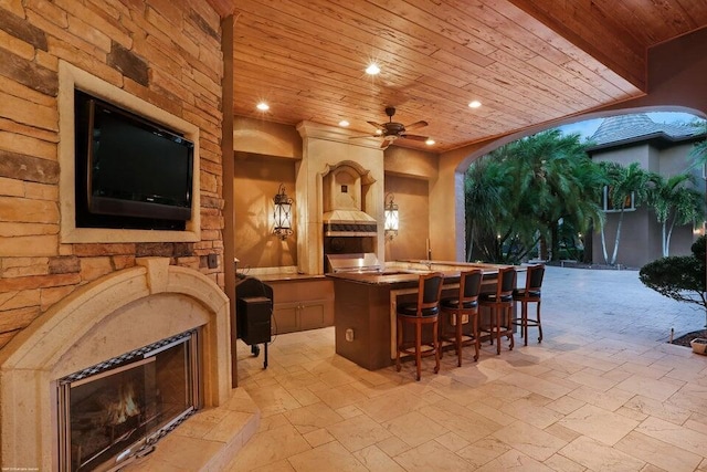 bar with wooden ceiling, stone tile floors, recessed lighting, and ceiling fan
