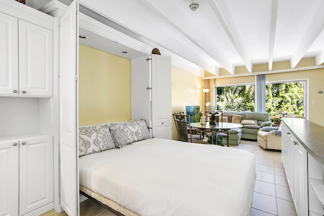 4001 S Ocean Blvd Unit 118, South Palm Beach, FL 33480 - bedroom featuring beamed ceiling and light tile patterned floors