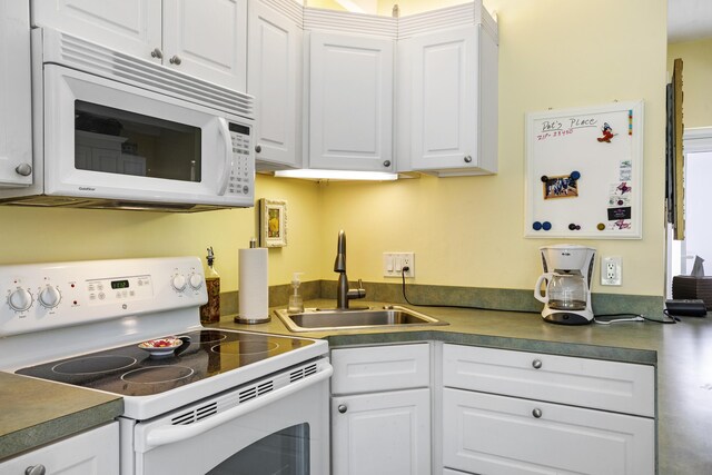 4001 S Ocean Blvd Unit 118, South Palm Beach, FL 33480 - kitchen with white appliances, a sink, white cabinets, and dark countertops