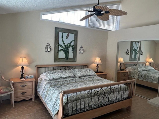bedroom featuring wood finished floors, ceiling fan, and a closet