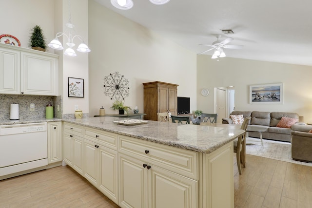 1801 S US Highway 1 Unit 7C, Jupiter, FL 33477 - kitchen with white dishwasher, a peninsula, high vaulted ceiling, light wood-style floors, and light stone countertops