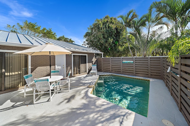 view of pool featuring a patio area and fence