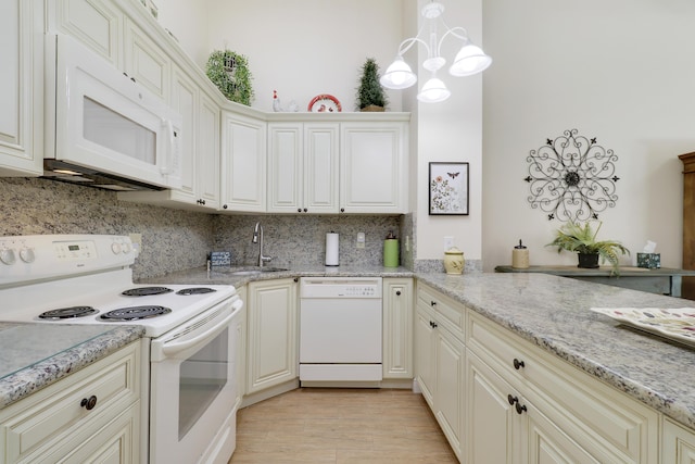1801 S US Highway 1 Unit 7C, Jupiter, FL 33477 - kitchen with white appliances, decorative backsplash, a sink, light stone counters, and pendant lighting