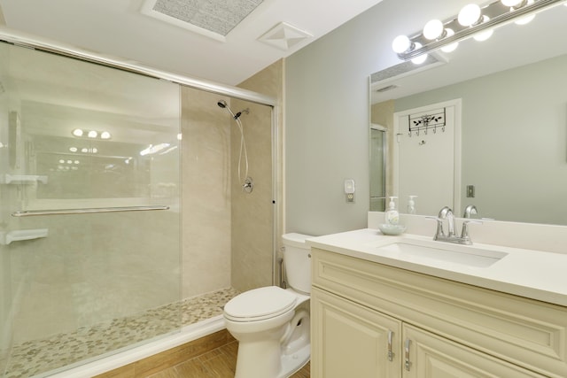 1801 S US Highway 1 Unit 7C, Jupiter, FL 33477 - bathroom featuring toilet, vanity, a shower stall, and wood finished floors