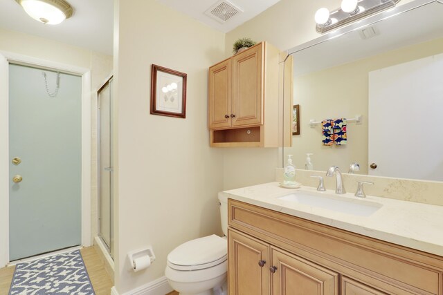 1801 S US Highway 1 Unit 7C, Jupiter, FL 33477 - bathroom featuring vanity, toilet, a shower with shower door, and wood finished floors