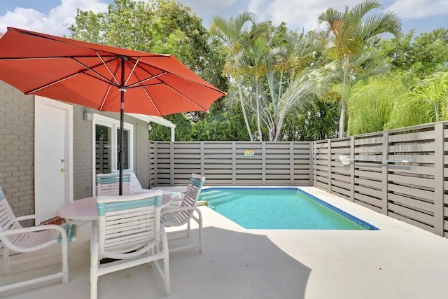 1801 S US Highway 1 Unit 7C, Jupiter, FL 33477 - view of swimming pool with a fenced backyard, a patio, and outdoor dining space