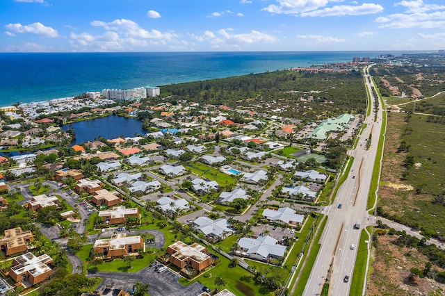 aerial overview of property's location with a nearby body of water and nearby suburban area