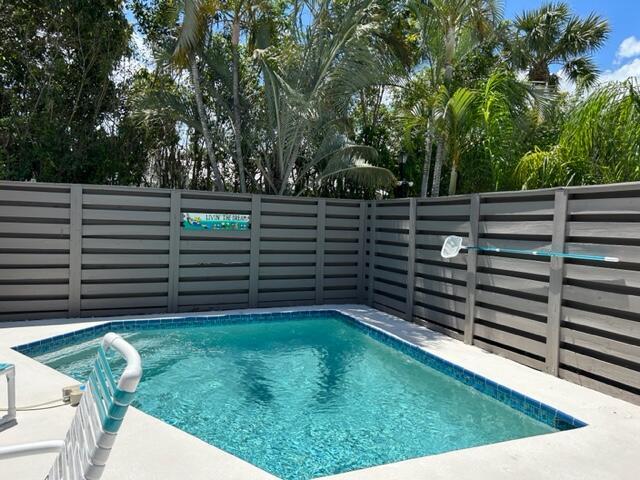 view of pool featuring fence