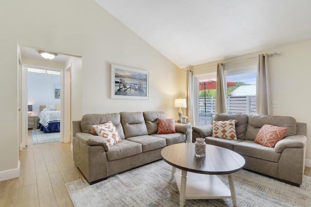 1801 S US Highway 1 Unit 7C, Jupiter, FL 33477 - living room with light wood-style flooring, high vaulted ceiling, and baseboards