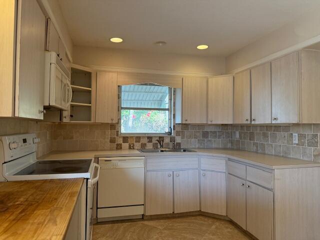 kitchen featuring white appliances, a sink, backsplash, open shelves, and recessed lighting