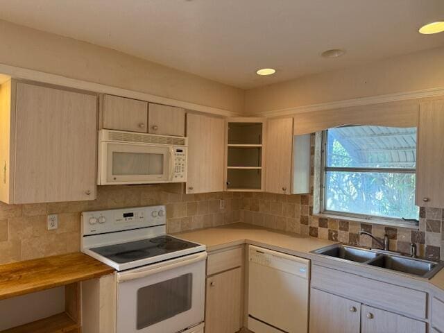 kitchen with white appliances, a sink, light countertops, open shelves, and tasteful backsplash