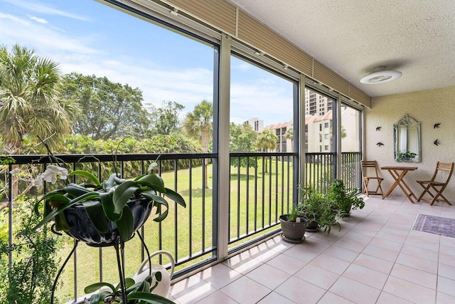 2520 Presidential Way Unit 203, West Palm Beach, FL 33401 - sunroom / solarium featuring a textured ceiling and tile patterned flooring