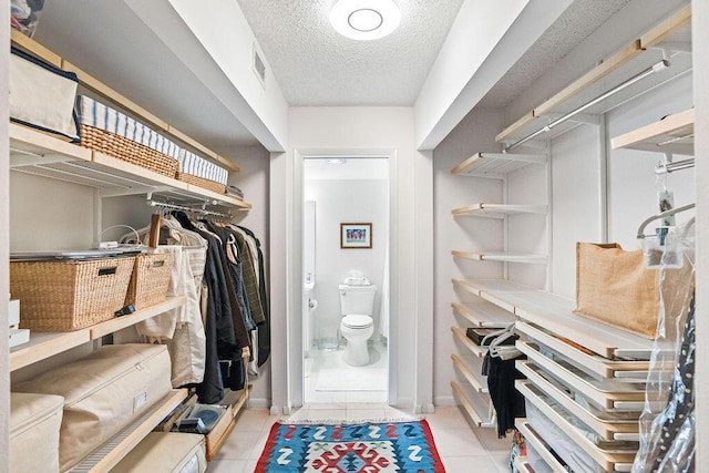 2520 Presidential Way Unit 203, West Palm Beach, FL 33401 - walk in closet featuring tile patterned flooring