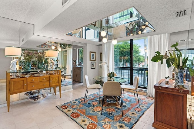 2520 Presidential Way Unit 203, West Palm Beach, FL 33401 - dining space with a textured ceiling, light tile patterned flooring, and expansive windows