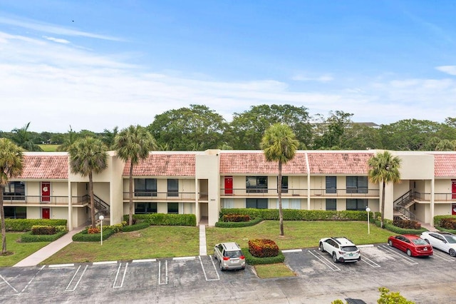 2520 Presidential Way Unit 203, West Palm Beach, FL 33401 - view of building exterior with uncovered parking