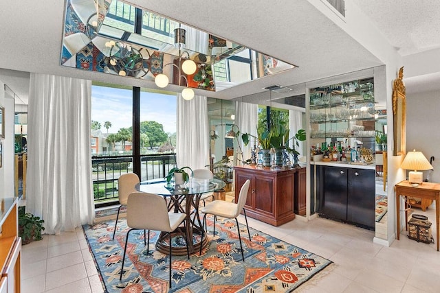 2520 Presidential Way Unit 203, West Palm Beach, FL 33401 - tiled dining room featuring a textured ceiling