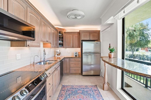 2520 Presidential Way Unit 203, West Palm Beach, FL 33401 - kitchen with appliances with stainless steel finishes, a sink, healthy amount of natural light, and light stone counters
