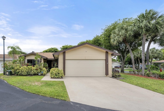 1 Danby Pl, Boynton Beach, FL 33426 - view of front of home featuring brick siding, a front yard, driveway, and a garage