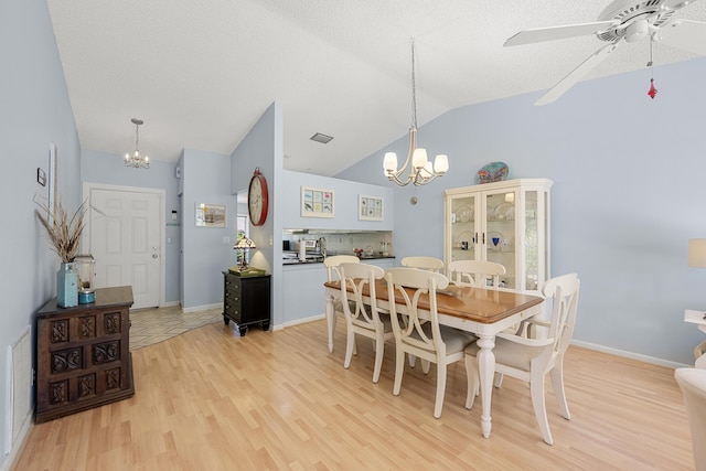 1 Danby Pl, Boynton Beach, FL 33426 - dining space with a chandelier, vaulted ceiling, light wood-style flooring, a ceiling fan, and baseboards