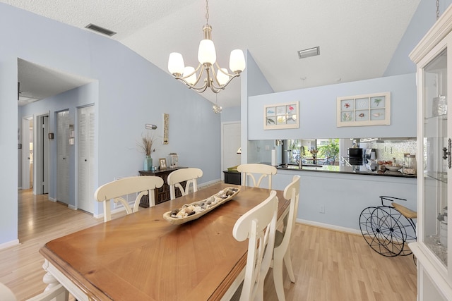 1 Danby Pl, Boynton Beach, FL 33426 - dining area with vaulted ceiling, a chandelier, light wood-style floors, and baseboards